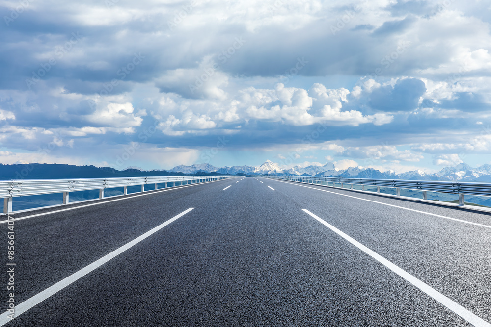 Straight asphalt highway road and snow mountains with sky clouds natural landscape. car background. Straight asphalt highway road and snow mountains with sky clouds natural landscape. car background.