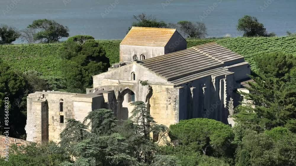 French coastal town of Maguelone and its cathedral seen closer, Aerial dolly out reveal shot French coastal town of Maguelone and its cathedral seen closer, Aerial dolly out reveal shot