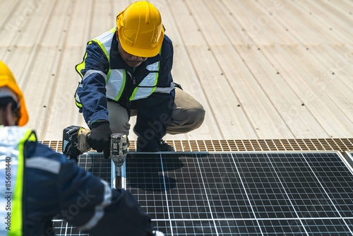 engineer man inspects construction of solar cell panel or photovoltaic cell by electronic device. Industrial Renewable energy of green power. factory worker working on tower roof.