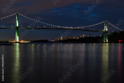 Lions Gate Bridge and Vancouver Skyline at night as seen from Ambleside Park in West Vancouver photo