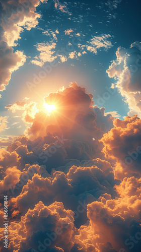 Heavenly cloudscape with the sun at dusk breaking through the clouds, epic sundown background