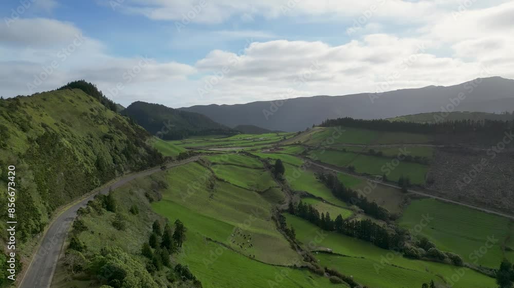 Aerial panoramic view of verdant pastures amidst the mountains. Daylight Aerial panoramic view of verdant pastures amidst the mountains. Daylight