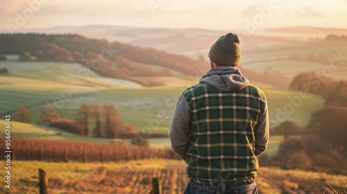 Contemplative Farmer Overlooking Fields at Sunrise from Hilltop