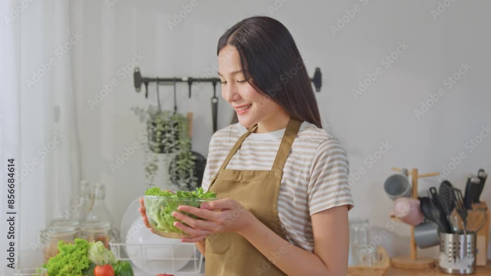 Portrait of Asian woman cooking green healthy salad in kitchen at home. Portrait of Asian woman cooking green healthy salad in kitchen at home.