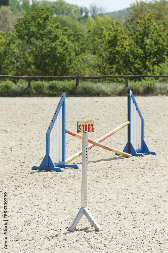 Horse obstacle course outdoors summertime. Poles in the sand for equestrian event Horse obstacle course outdoors summertime. Poles in the sand for equestrian event