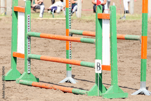  Horse obstacle course outdoors summertime. Poles in the sand for equestrian event