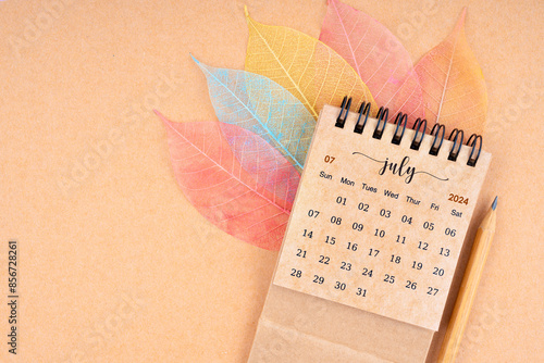 July 2024 monthly desk calendar and fiber structure of dry leaves texture, skeleton leaf. photo