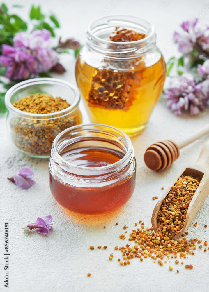 Raw organic bee pollen and honey in jars. Raw organic bee pollen and honey in jars.