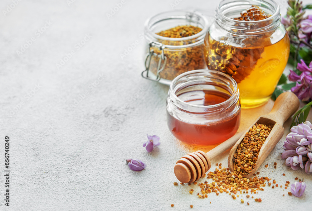 Raw organic bee pollen and honey in jars. Raw organic bee pollen and honey in jars.