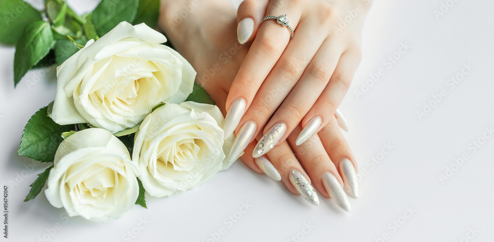 Female Hands on a white background with beautiful pearl manicure Female Hands on a white background with beautiful pearl manicure