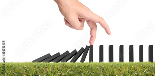 Hand stopping the Domino effect stopped by unique