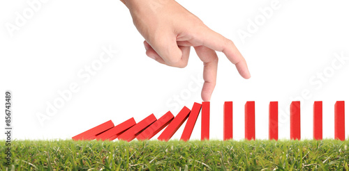 Hand stopping the Domino effect stopped by unique