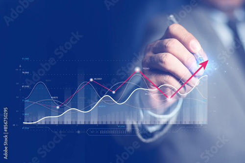 Businessman or trader touching showing a growing virtual hologram stock, invest in trading. Planning and strategy, Stock market, Business growth, progress or success concept.