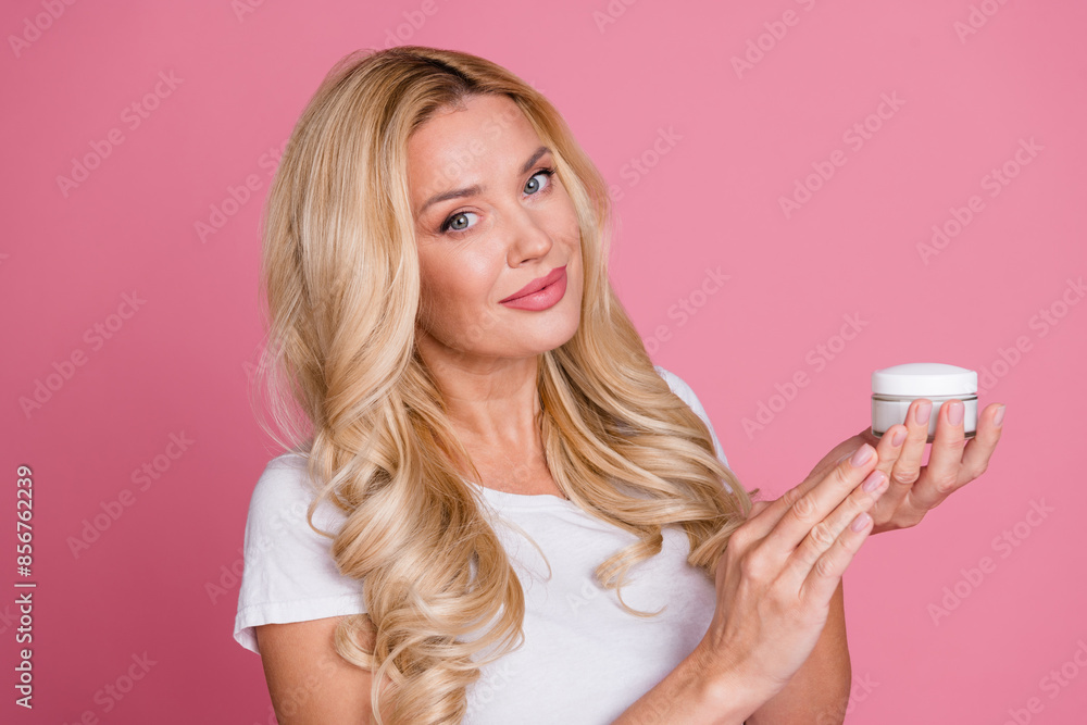 Photo of cheerful pretty lady dressed white t-shirt apply hand cream empty space isolated pink color background Photo of cheerful pretty lady dressed white t-shirt apply hand cream empty space isolated pink color background
