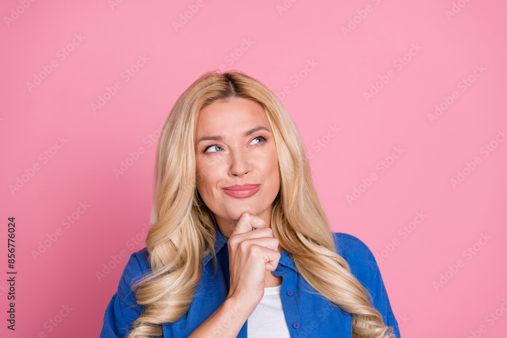 Photo of cheerful thoughtful lady dressed blue jacket arm chin looking empty space isolated pink color background Photo of cheerful thoughtful lady dressed blue jacket arm chin looking empty space isolated pink color background