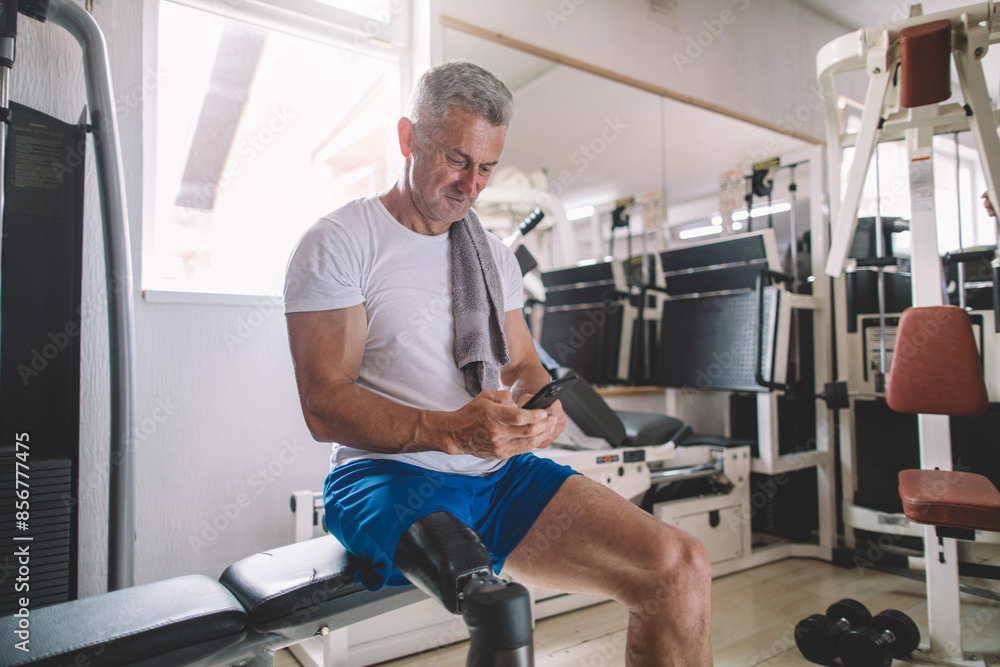 Inspiring veteran amputee using smartphone after workout Inspiring veteran amputee using smartphone after workout