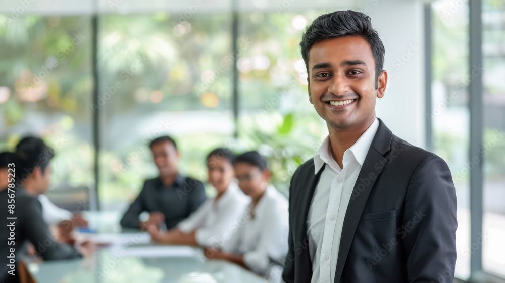 Confident Indian Male Executive Smiling During a Corporate Discussion, Professional Work Environment Confident Indian Male Executive Smiling During a Corporate Discussion, Professional Work Environment