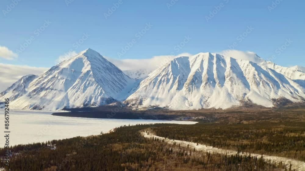 Snow covered mountains with lake and forest Snow covered mountains with lake and forest