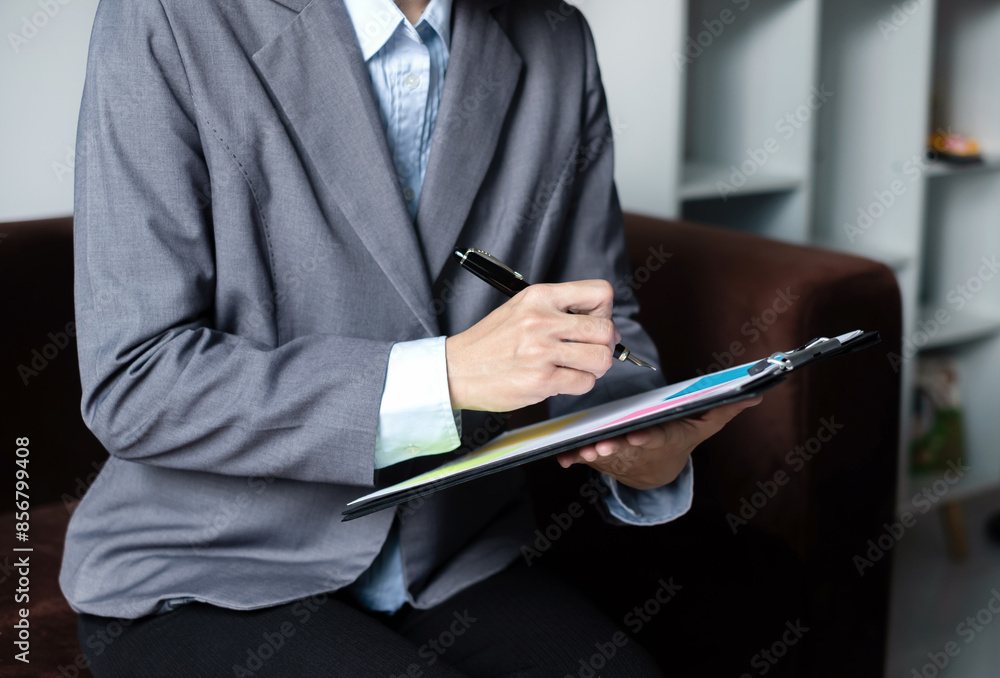 Asian businesswoman calculate financial graphs showing results about their investments, plan a successful business growth process Asian businesswoman calculate financial graphs showing results about their investments, plan a successful business growth process