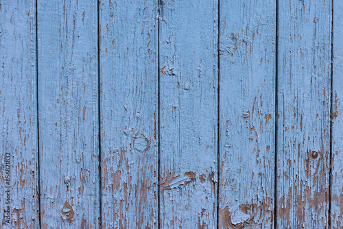 arrière plan texturé constitué de vieilles planches de bois, recouvertes de peinture bleue écaillée. Gros plan sur des portes, volets ou palissade photo
