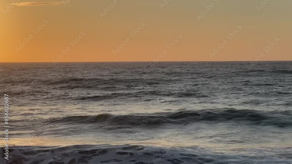 Slightly fluttering sea against a bright orange sunset Slightly fluttering sea against a bright orange sunset