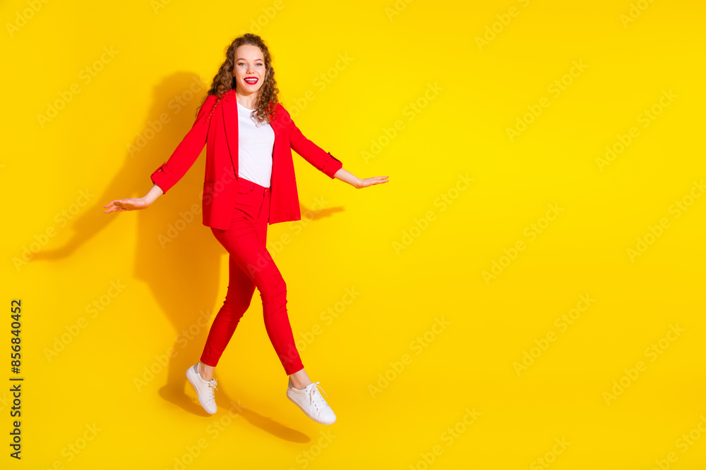 Full body portrait of gorgeous young lady jump run empty space wear red suit isolated on yellow color background Full body portrait of gorgeous young lady jump run empty space wear red suit isolated on yellow color background