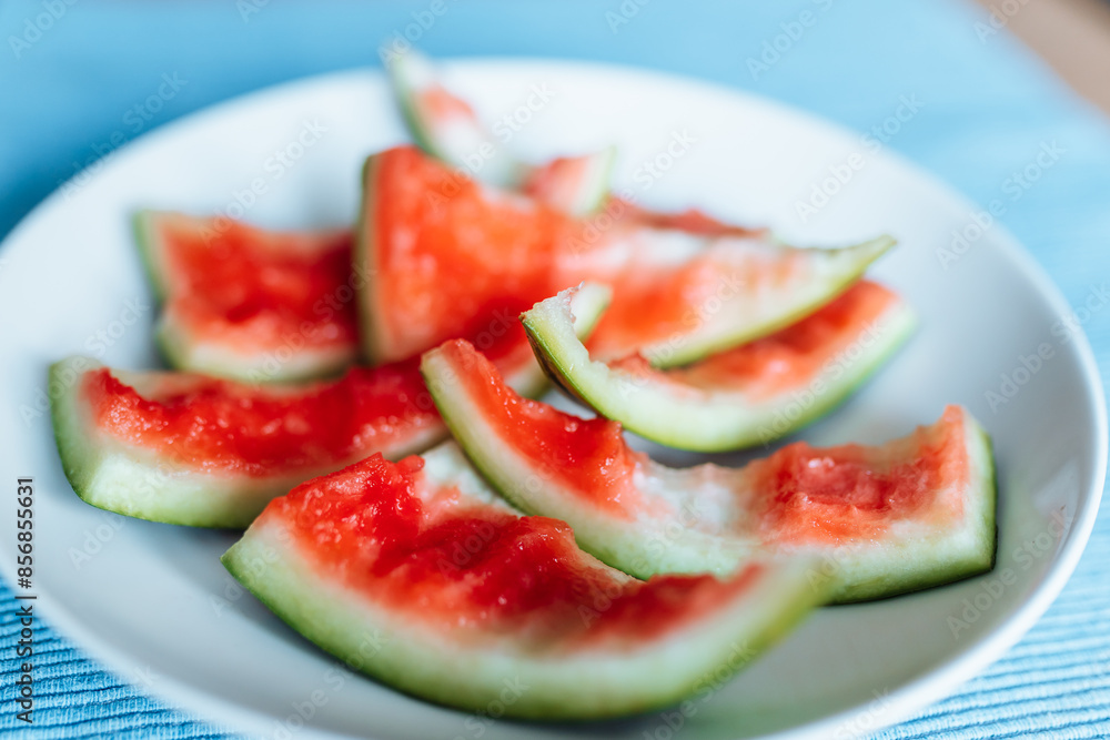 watermelon rinds with leftover watermelon on plate watermelon rinds with leftover watermelon on plate