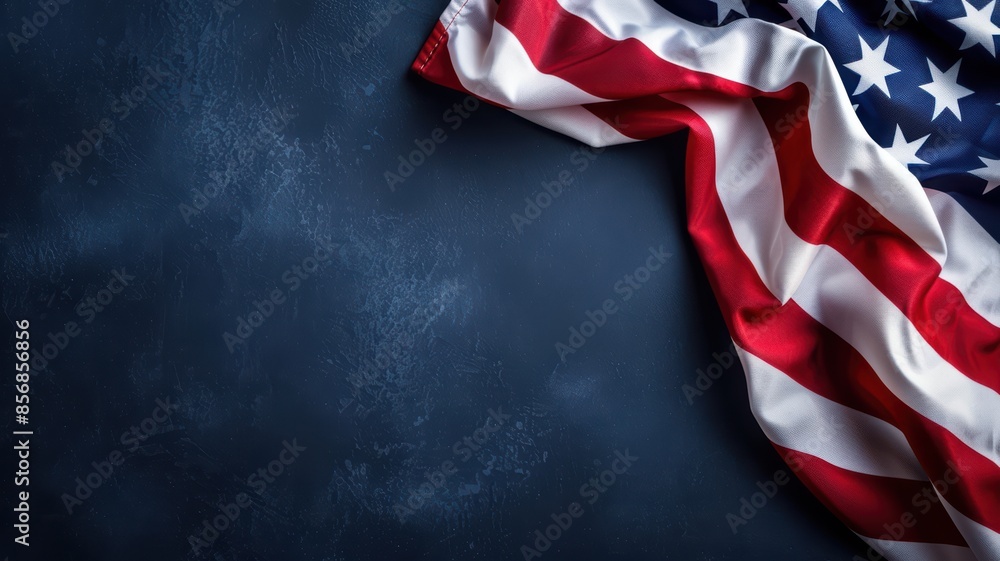 American Flag Draped on Dark Blue Textured Background - Patriotic Symbol of the United States of America American Flag Draped on Dark Blue Textured Background - Patriotic Symbol of the United States of America