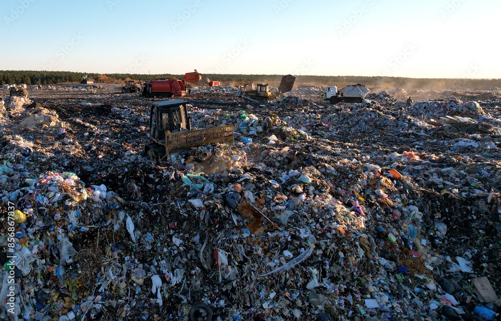 Landfill garbage truck. Garbage truck unloads rubbish in landfill ...