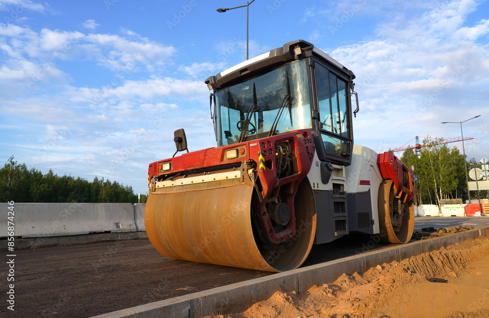 Roadworks, Road construction. Paving roller on roadworks at construction site, paving works. Asphalt paver Road roller on ground Screeding, road concreting. Paving works. Compact soil, gravel, paving Roadworks, Road construction. Paving roller on roadworks at construction site, paving works. Asphalt paver Road roller on ground Screeding, road concreting. Paving works. Compact soil, gravel, paving