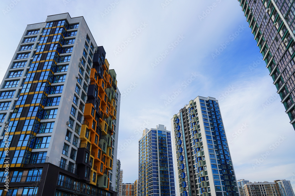 Facade building. Modern building and houses against blue sky. Colorful buildings with glass windows, balconies. Buildings architecture. Skyline Skyscrapers. Urban Residential building exterior. Facade building. Modern building and houses against blue sky. Colorful buildings with glass windows, balconies. Buildings architecture. Skyline Skyscrapers. Urban Residential building exterior.