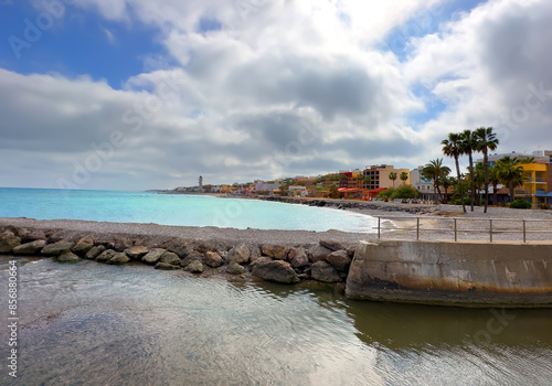 Pebble stone beach in Nules, Castello. Sea beach shore. Waves in sea near coastline on empty pebble beach. Sea beach landscape. Coast pebbles. Shore landscape on Spain resort. Ocean shoreline scenic. photo