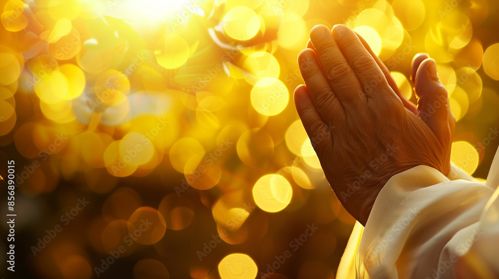 Obraz premium Closeup Hands Praying Pose with Golden Bokeh Background