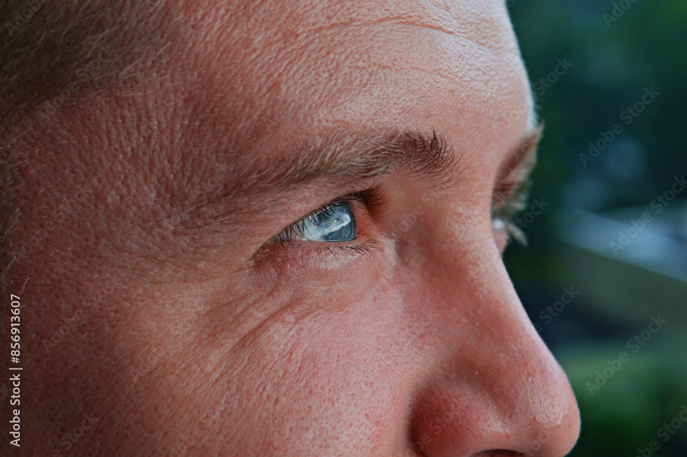 Fototapeta premium Handsome man looking away. eye examination, laser surgery, optical store, advertisement of lenses and glasses, concept of services of ophthalmologic clinic