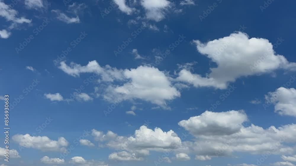 Blue summer sky with dense thick thunderstorm rain clouds moving across the heavens. Fast cloud formation and movement creating a surreal time lapse. Blue summer sky with dense thick thunderstorm rain clouds moving across the heavens. Fast cloud formation and movement creating a surreal time lapse.