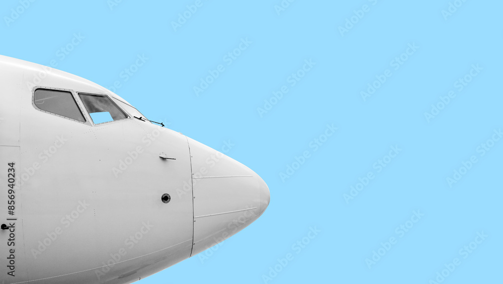 Airplane. Front section. Large commercial airliner cabin windows and bodywork sensors. Blue sky clouds background. Airplane. Front section. Large commercial airliner cabin windows and bodywork sensors. Blue sky clouds background.