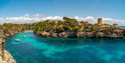 Panoramic view of the beautiful Cala Pi cove and the ancient watch tower built in 1597, in the municipality of Llucmajor, Majorca, Balearic Islands, Spain photo