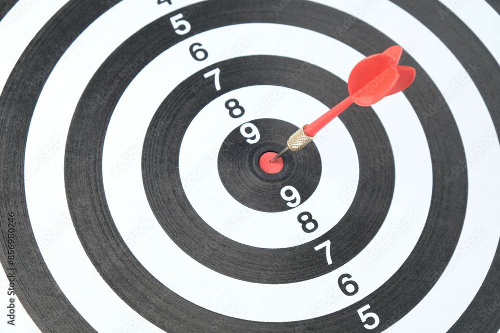 Dart in the center of the dartboard, concept of hitting the target, reaching the goal, determination Dart in the center of the dartboard, concept of hitting the target, reaching the goal, determination