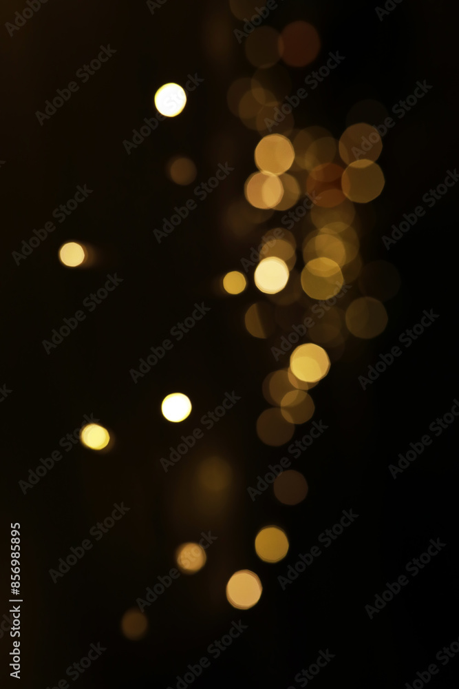 Fototapeta premium Abstract Defocused Yellow Lights on Dark Background - Modern and Artistic Bokeh Effect in Photography