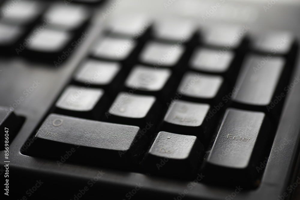 Close-Up of Black Computer Keyboard Keys Highlighting the Enter Button for Technology and Office Work Concepts Close-Up of Black Computer Keyboard Keys Highlighting the Enter Button for Technology and Office Work Concepts