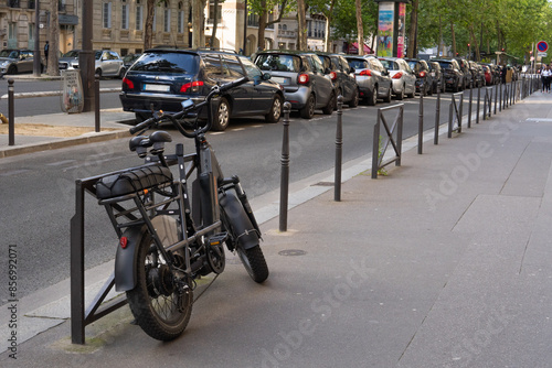 Electric bike in the streets of Paris, France. Sustainable travel. Green city.