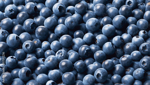 In the photograph of blueberries filling the entire frame, the berries have a rich blue color with a slight grayish coating and characteristic indentations are visible at the base of each berry photo