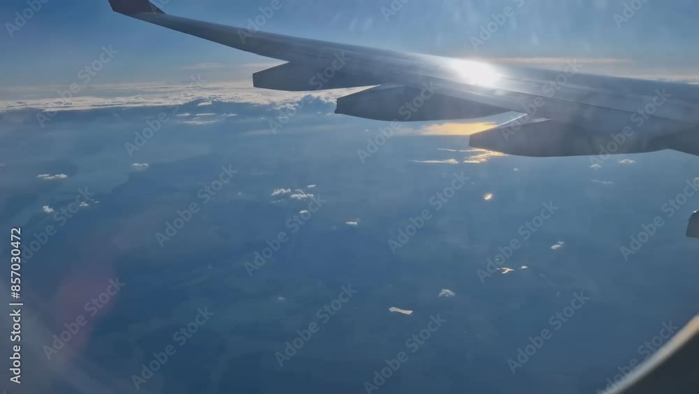 The view from the window of an air plane of clouds and blue sunny sky. The view from the window of an air plane of clouds and blue sunny sky.