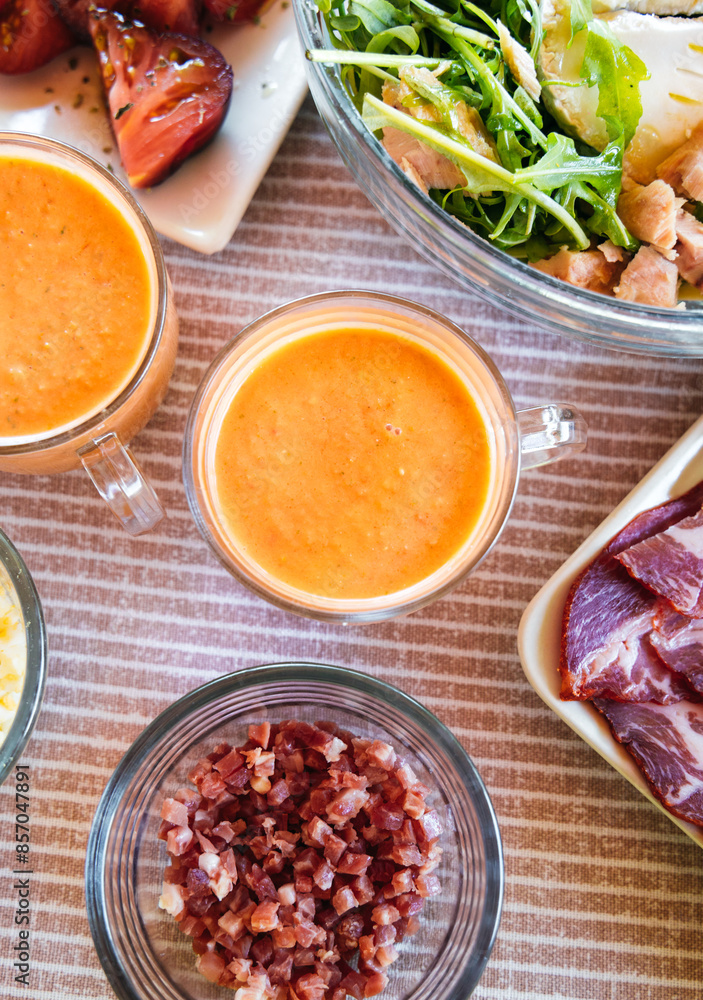 Spanish Salmorejo with Assorted Tapas on a Table Spanish Salmorejo with Assorted Tapas on a Table