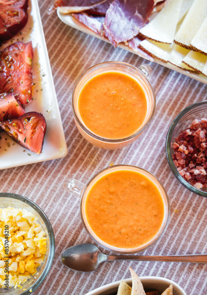 Spanish Salmorejo with Assorted Tapas on a Table Spanish Salmorejo with Assorted Tapas on a Table