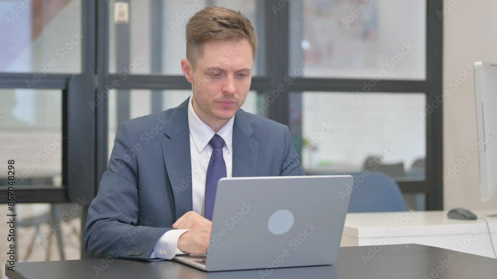 Pensive Mature Adult Businessman Reading on Laptop Pensive Mature Adult Businessman Reading on Laptop