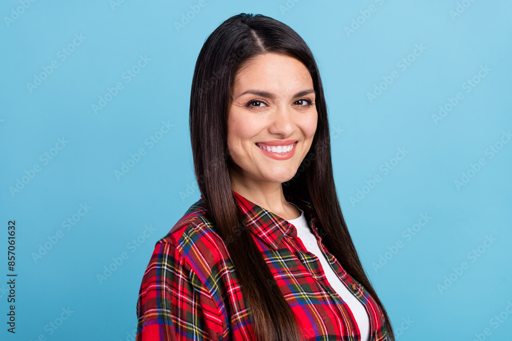 Portrait photo of beautiful charming mature woman in checkered red shirt smiling glad looking at you isolated on blue color background Portrait photo of beautiful charming mature woman in checkered red shirt smiling glad looking at you isolated on blue color background