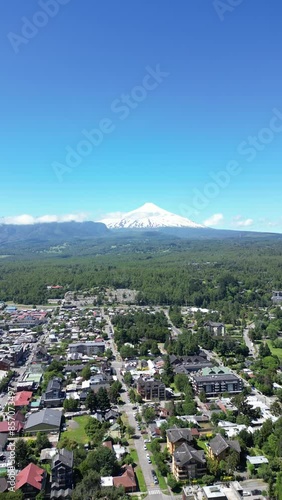 Aerial video over the town of Pocon in the background of the active volcano Villarrica, Chile photo