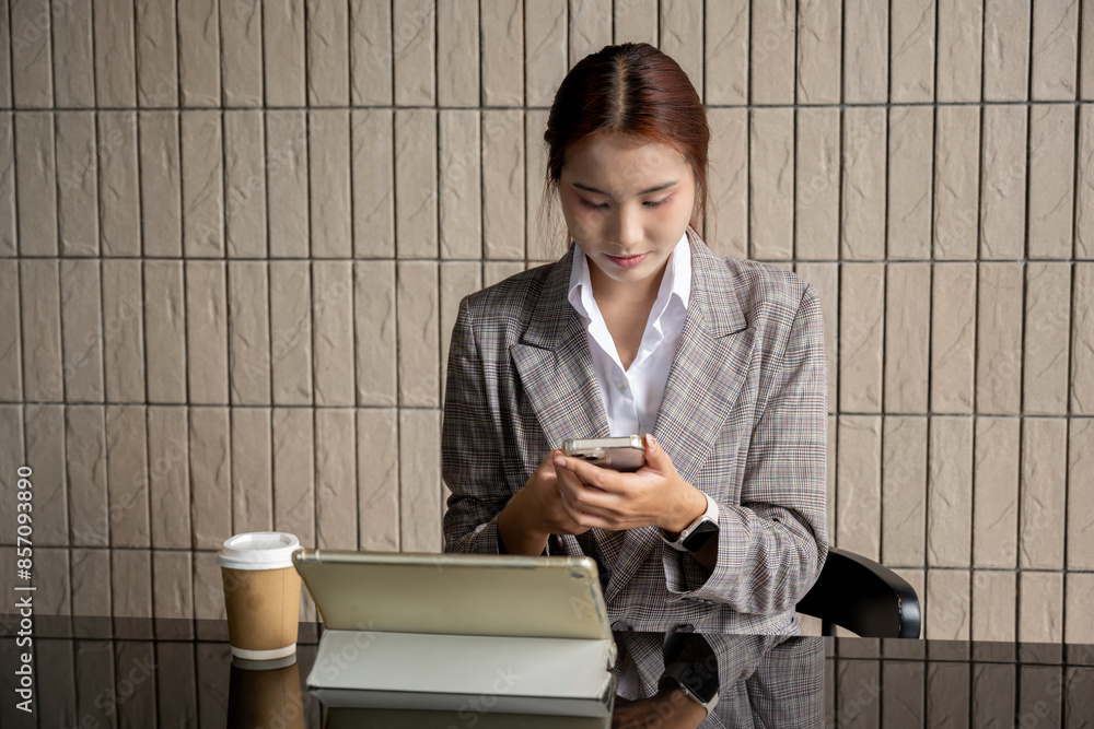 A beautiful young Asian businesswoman or female secretary working on her laptop computer in a office. businesspeople, technology A beautiful young Asian businesswoman or female secretary working on her laptop computer in a office. businesspeople, technology