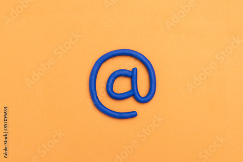 'at' sign. 3d email symbol on orange background. E Mail icon, concept for internet, contact us and e-mail address. 